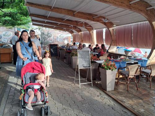 a woman with a baby in a stroller and a woman with a child at Guest House Plan B in Rafailovici