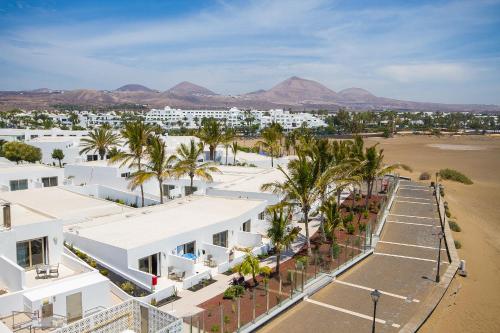 an aerial view of a resort with palm trees at Hotel Las Costas in Puerto del Carmen