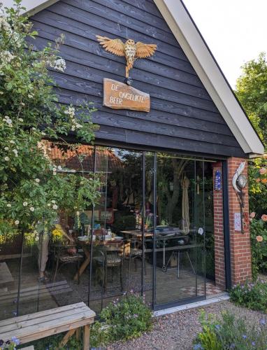 a restaurant with an owl sign on the front of it at De Berin in Westhoek