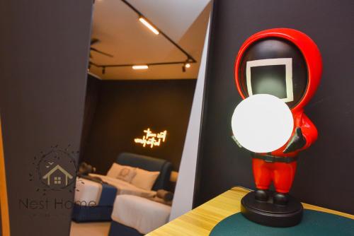 a red mirror sitting on top of a table in a room at Twin Tower Residence by Nest Home【5 mins walk to CIQ】 in Johor Bahru