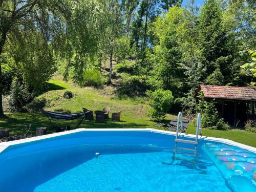 a swimming pool in a yard next to a house at La Maison du Chevalier in Marat