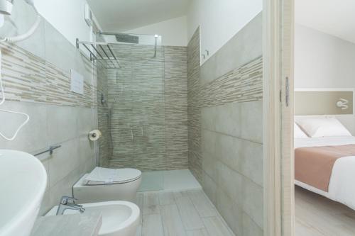 a bathroom with a toilet sink and a shower at VeMi Affittacamere in Posada