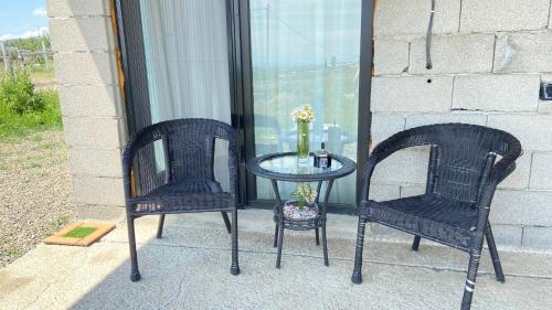 two chairs and a table on a patio at temuka in Samgori