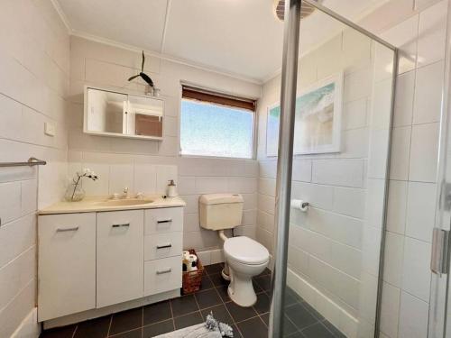 e bagno con servizi igienici, lavandino e doccia. di Stylish Apartment by the sea a Port Hedland