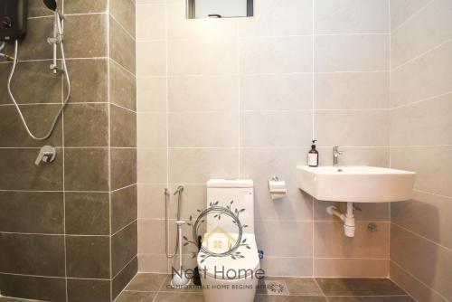 a bathroom with a toilet and a sink at Twin Tower Residence by Nest Home【5 mins walk to CIQ】 in Johor Bahru