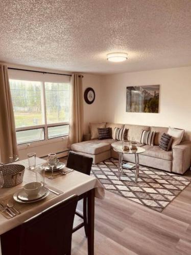 a living room with a couch and a table at North Star Place Apt 12 (premium) in Fairbanks