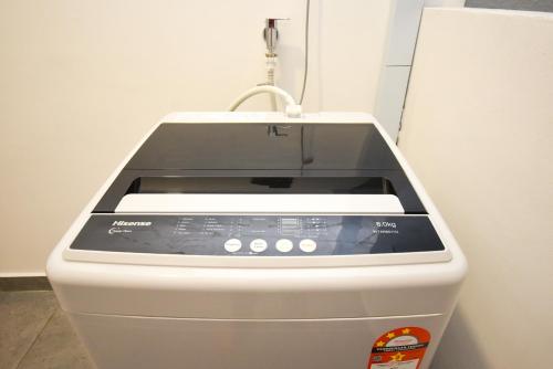 a toaster oven sitting on top of a refrigerator at Twin Tower Residence by Nest Home【5 mins walk to CIQ】 in Johor Bahru