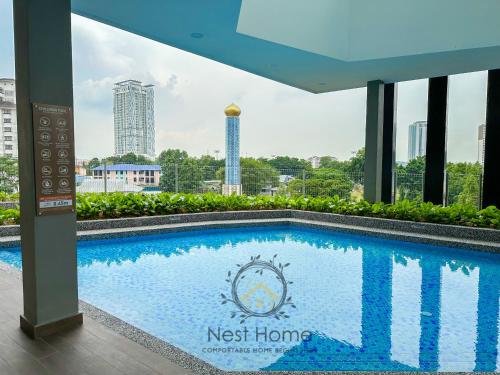 a swimming pool on the roof of a building at Twin Tower Residence by Nest Home【5 mins walk to CIQ】 in Johor Bahru