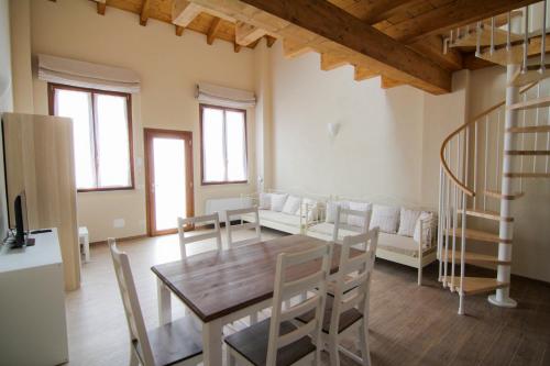 a dining room with a wooden table and chairs at Agriturismo Cascina della Fontana in Lodi