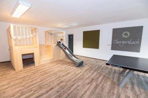 a living room with a slide and a piano at Obergersbach in Floitensberg