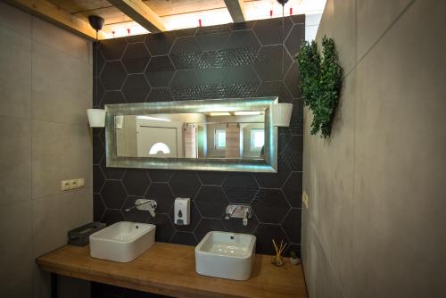 łazienka z 2 umywalkami i lustrem na ścianie w obiekcie Rock Oak Camp w mieście Imotski