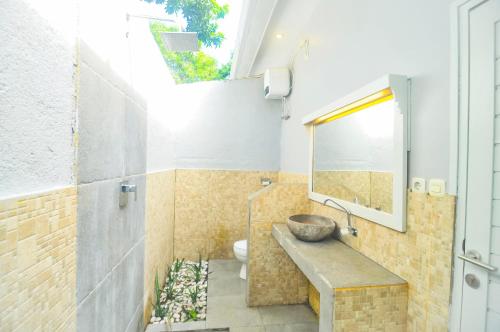 a bathroom with a sink and a toilet at Follow Your Dreams Gili Air in Gili Air
