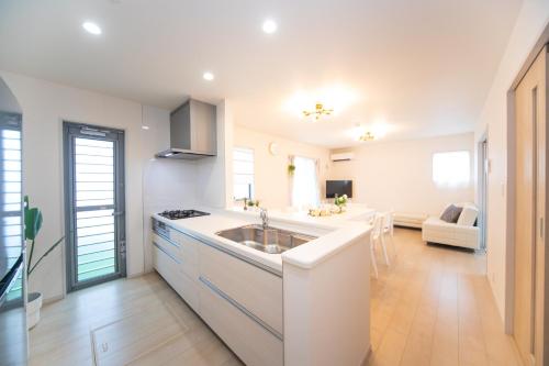 a kitchen with a sink and a stove at Nagashima Riverside Resort 2 in Hakuro