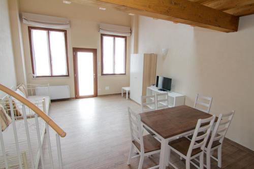a kitchen and dining room with a table and chairs at Agriturismo Cascina della Fontana in Lodi