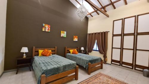 a bedroom with two beds and a window at Luxury holiday villas in Bahrain for Families in Bārbār