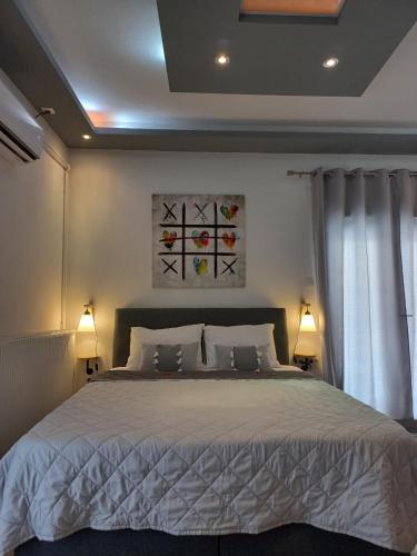 a bedroom with a large bed with two lamps at A&D Central Studio in Volos