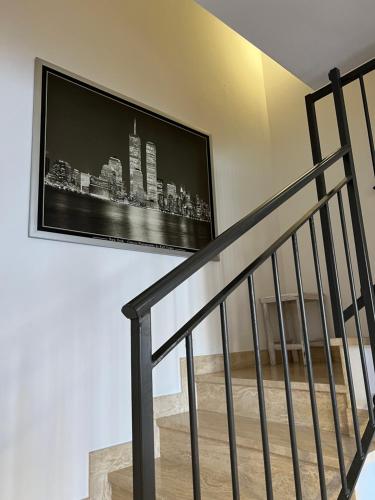 a television hanging on a wall next to a staircase at Le Corti di Legnano UNO Monolocali centralissimi in Legnano