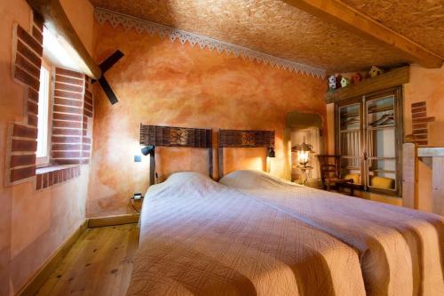 une chambre avec un grand lit dans une pièce dans l'établissement Grande maison de charme avec piscine au coeur des vergers et vignobles, à La Roche-de-Glun