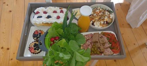 a tray of food on a table with plates of food at sosnowelowe in Lamkowo