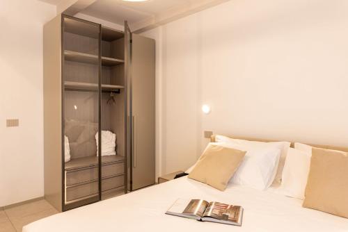 a bedroom with a bed with a book on it at TENUTA FOGLIANI Resort & Natural Spa in Visciano