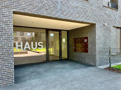 a large entrance to a building with a hulse sign on it at Seeparkvilla – Wohlfühlen am See und im Grünen in Bregenz