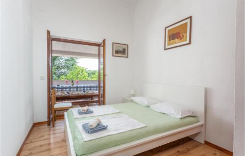 a bedroom with a bed with a mirror and a window at Nice Apartment In Pinezici With Wifi in Pinezici