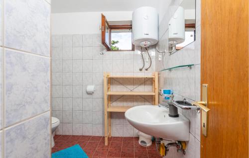 a bathroom with a sink and a toilet at Nice Apartment In Pinezici With Wifi in Pinezici