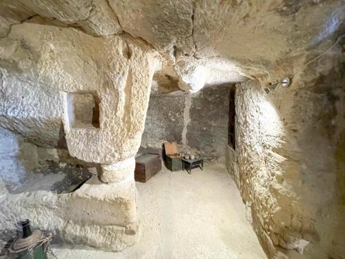 a room in a cave with a stone wall at La Casa del Poeta Enna - Pergusa in Enna