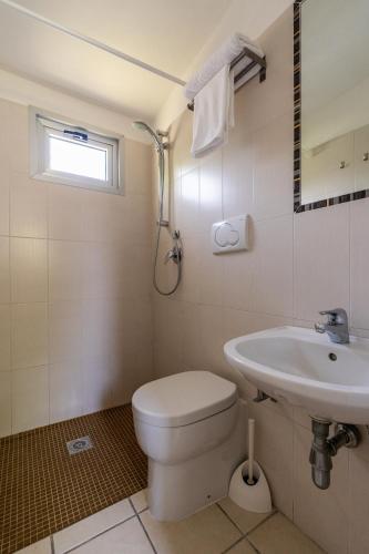 a bathroom with a toilet and a sink at La Conchiglia in Chioggia