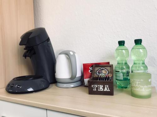 a counter with a coffee maker and bottles of water at Schönes zentrales Appartment mit TIEFGARAGE in Kassel