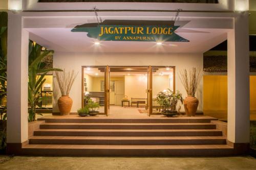 a lobby of an apartment building with stairs and plants at Jagatpur Lodge by Annapurna in Khargauli