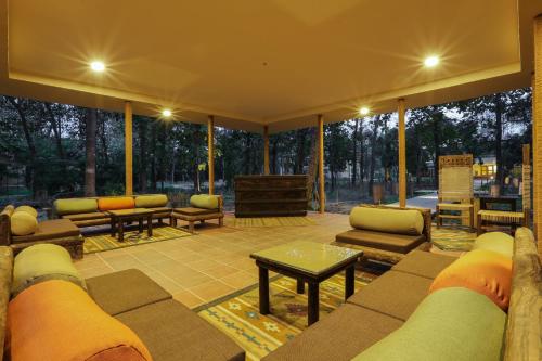 a large screened in porch with couches and a table at Jagatpur Lodge by Annapurna in Khargauli