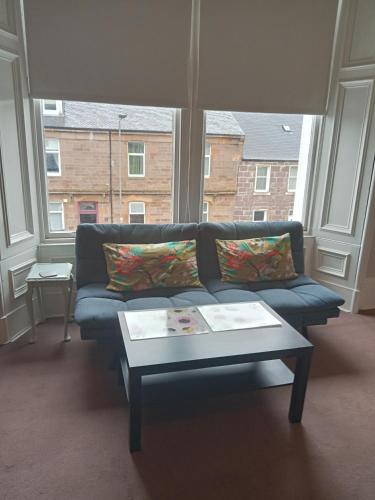 a living room with a couch and a coffee table at Braefoot Guest House in Campbeltown
