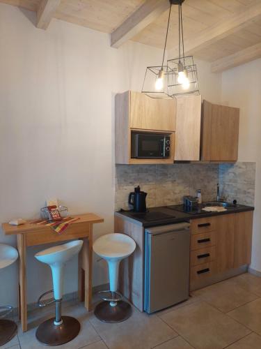 a kitchen with a counter and a table with stools at Zante Flower Studios & Apartments in Alikanas