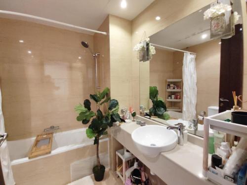 a bathroom with a sink and a toilet and a tub at House 369 in Ras al Khaimah