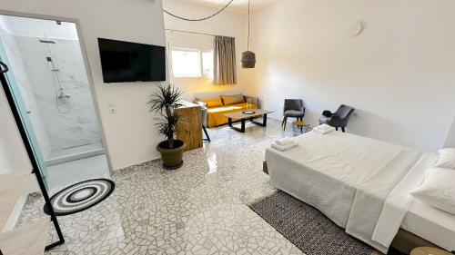 a bedroom with a bed and a living room at Falirala Central in Faliraki