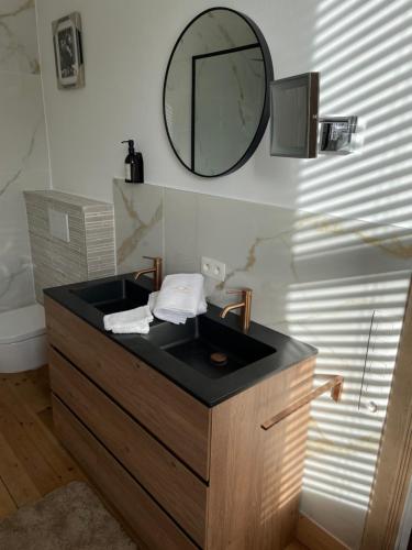 a bathroom with a sink and a mirror on the wall at Circa 1929 in Ostend