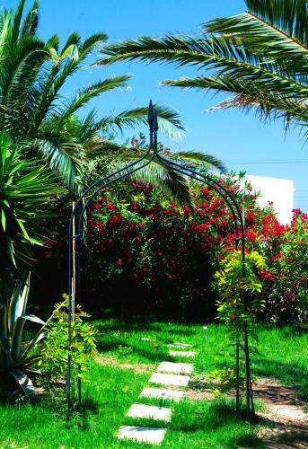 a statue of a bird sitting on top of a palm tree at ANCIENT MEROPIA, Apollonia in Apollonia