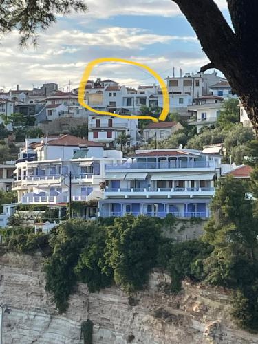 a large building with a yellow circle on top of it at The Stone House in Votsi