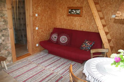 a living room with a red couch and a table at Türju rannamaja in Türju
