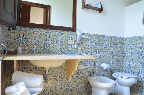 a bathroom with a sink and a toilet at GIARDINO del MARE in Petrosino