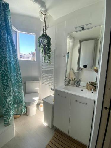 une salle de bain avec toilettes, lavabo et miroir dans l'établissement Paris : superbe appartement au coeur du Marais, à Paris