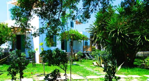 a white building with trees in front of it at ANCIENT MEROPIA, Apollonia in Apollonia