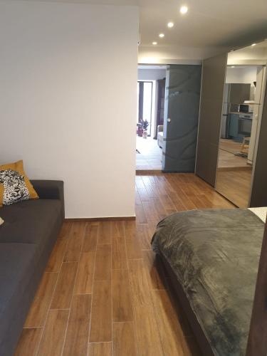 a bedroom with a bed and a living room at Apartma na klancu in Kobarid