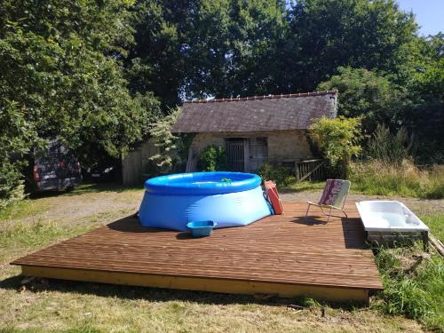 a large blue tub sitting on a wooden deck at Edel de la Touche Balard in Val Couesnon