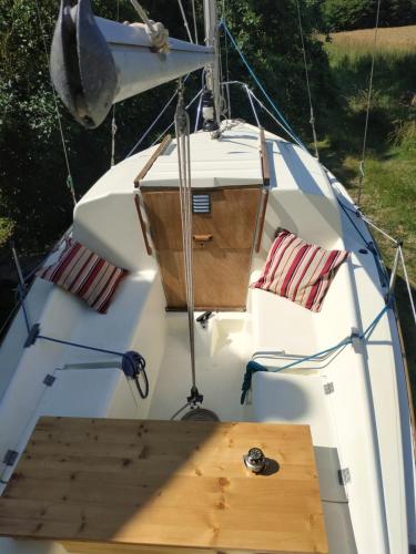 a boat with a wooden dock on the front at Edel de la Touche Balard in Val Couesnon