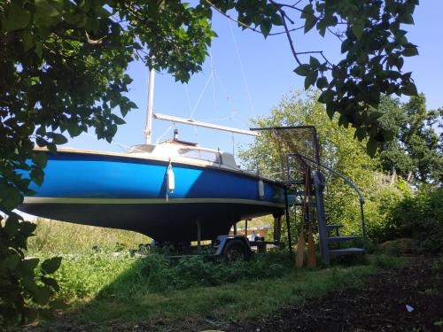 a blue boat on a trailer in the grass at Edel de la Touche Balard in Val Couesnon