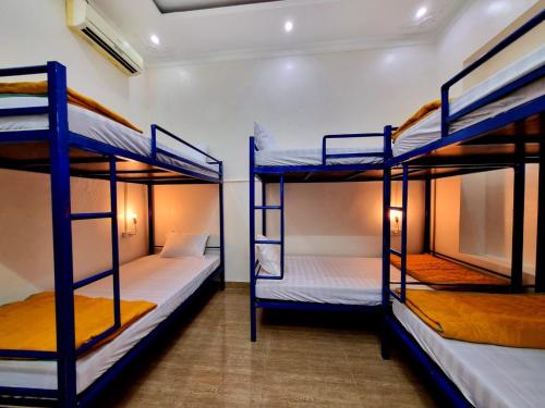 a room with three bunk beds in it at Ha Giang Donkey hostel in Ha Giang