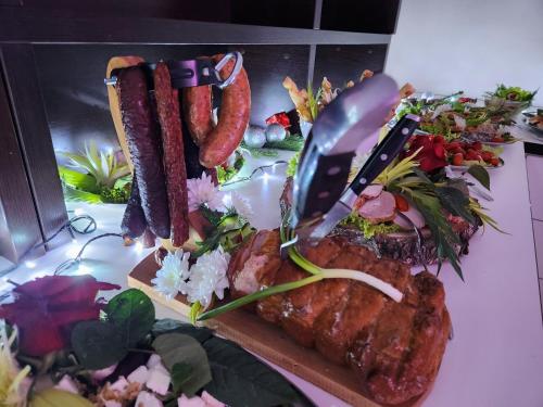 a plate of food with meat and vegetables on a table at Baltic Sun SPA in Rewal