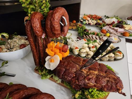 a buffet of food with meat and other foods at Baltic Sun SPA in Rewal